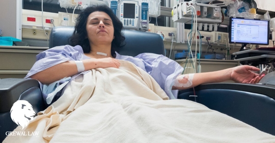 Grewal Law: Woman laying in hospital chair with an IV in her arm.
