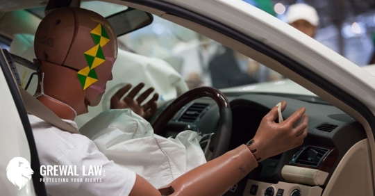 Crash test dummy inside a car in the driver's seat