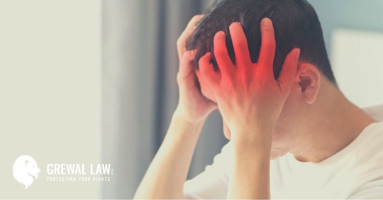 Man with hands on his head indicating a headache