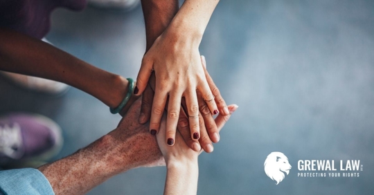 Group of men and women's hands on top of each other