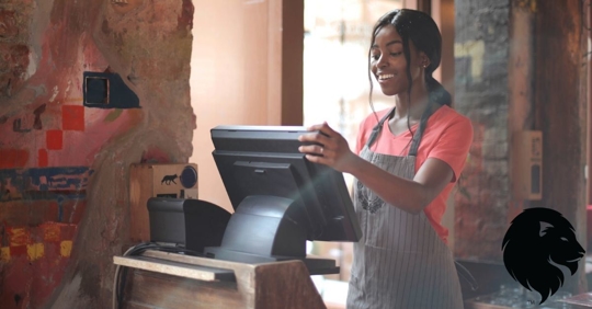 Young African American Woman Working a Cash Register at a Restaurant