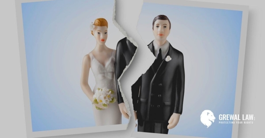 Photo of a cake topper of a bride and groom ripped down the middle between the bride and groom.