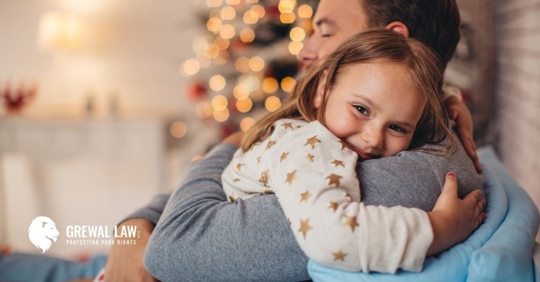 Little girl smiling hugging her father