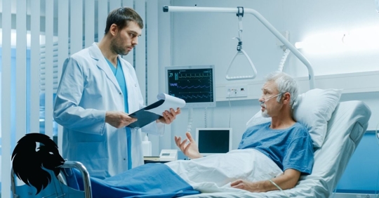 Doctor in hospital speaking to patient in bed